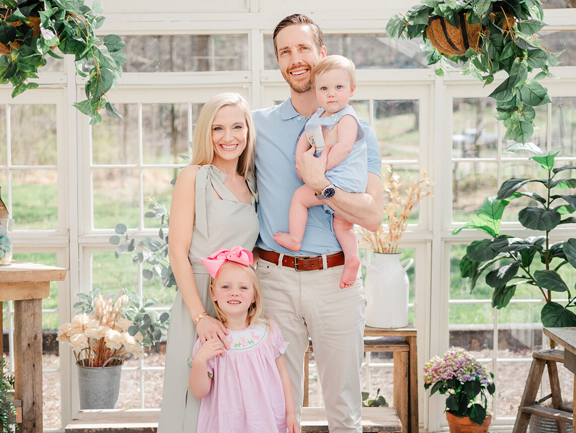 Mom, dad, son and daughter pose together in greenhouse at Forked Creek Farm for Spring Mini Session. 