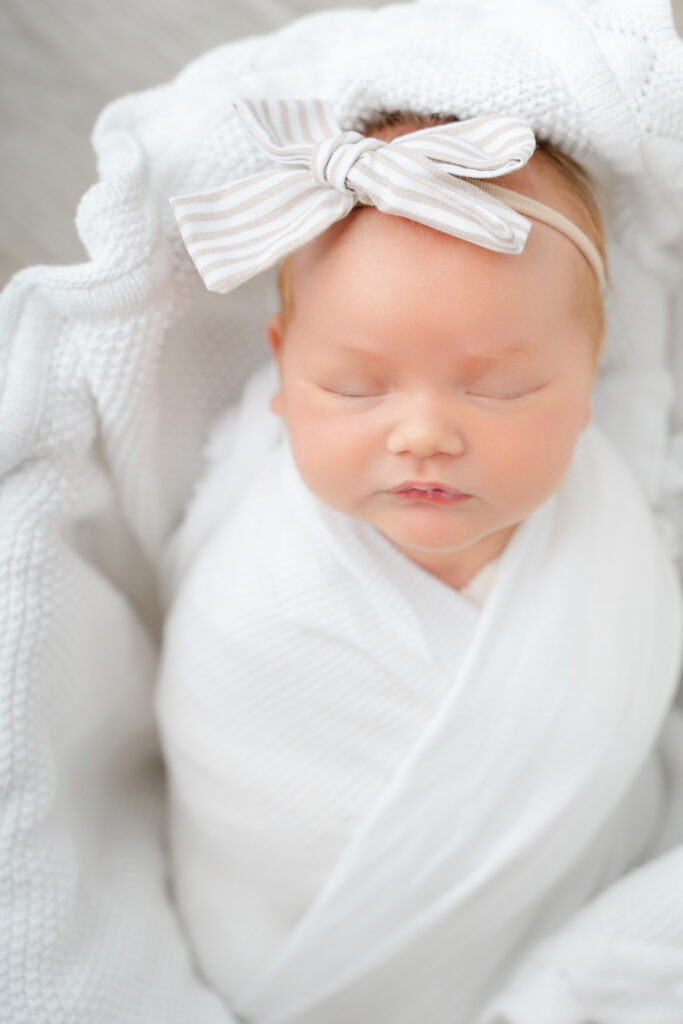 Newborn baby photographed in a light-filled lifestyle studio in Alpharetta.
