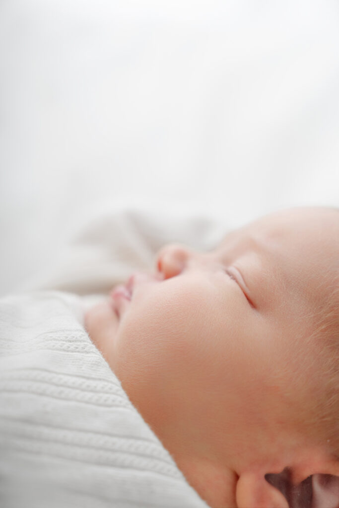 Newborn baby photographed in a light-filled lifestyle studio in Alpharetta.