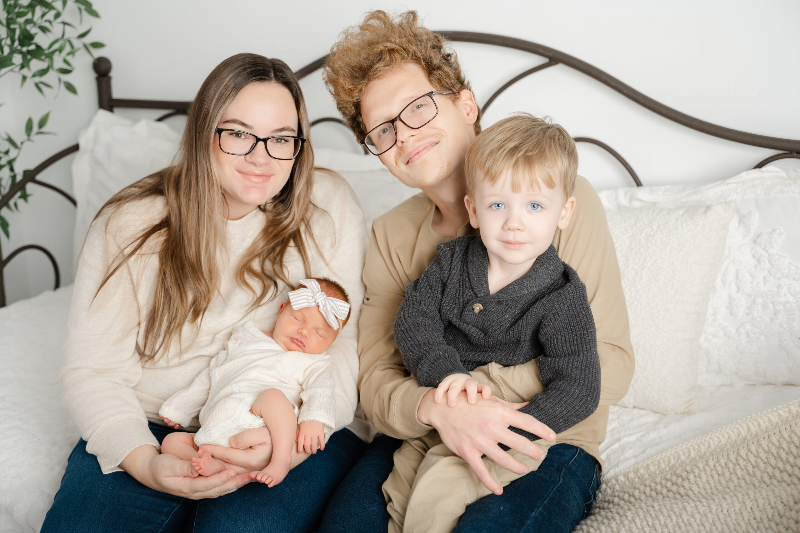 Family with newborn and sibling during a lifestyle studio newborn session.