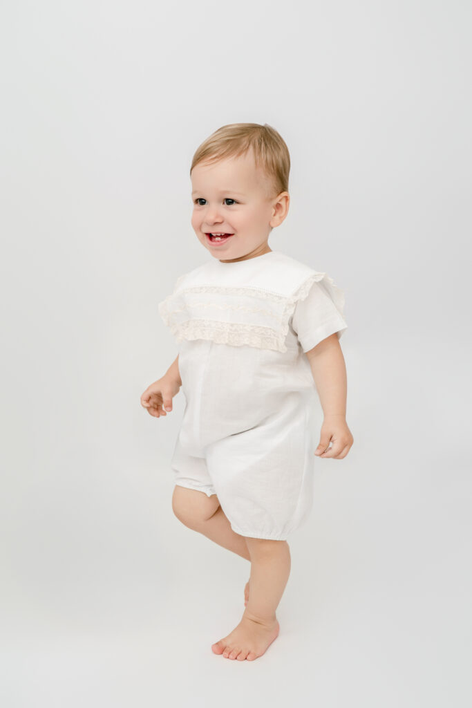 Toddler boy walking and smiling during a relaxed Atlanta heirloom photography session