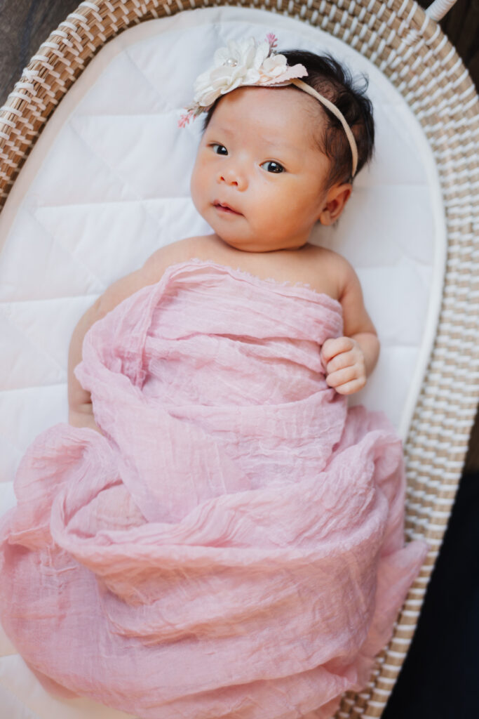 Baby girl in pink blanket at lifestyle in-home newborn session with Scarlet Oak Photography in Atlanta, GA