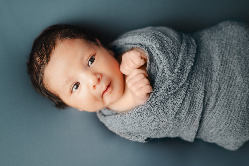 baby wrapped in blue swaddle blanket in atlanta newborn session