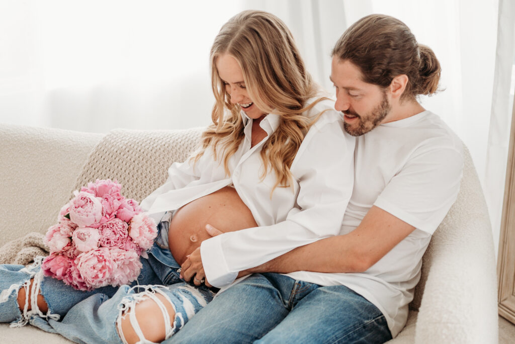 Mom and Dad admire pregnant belly during Woodstock, GA Maternity Session.