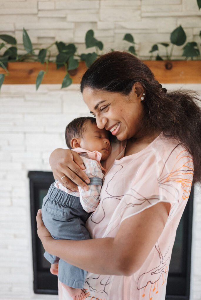 Mom embracing newborn boy in Cumming Newborn Photography Session